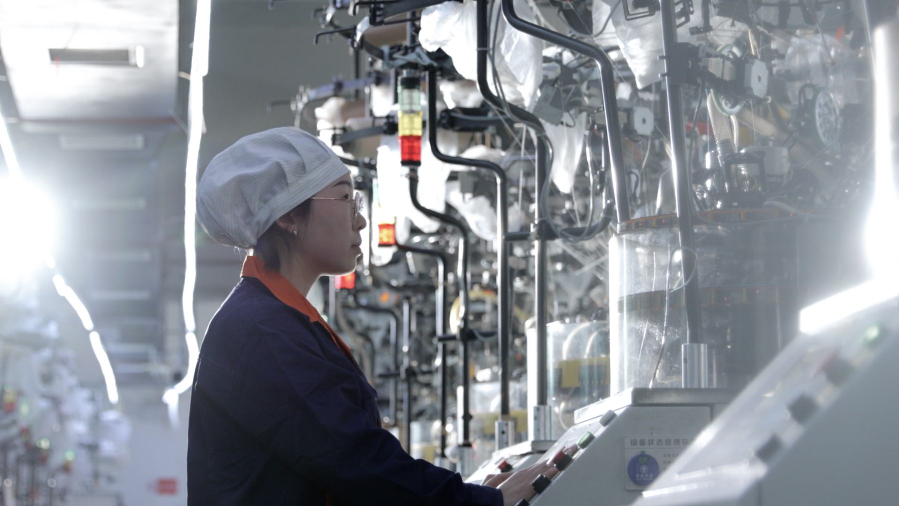 MAIZI operator working with medical hosiery knitting equipment